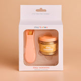 Baby food jar and spoon set in 'tiny harlow' packaging on a beige background