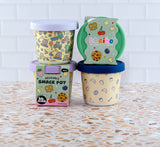 Set of reusable snack pots with colorful designs on a tiled surface
