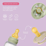 Baby Sprinkle gift set with pacifiers and bottle on a purple background