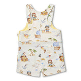 A baby romper with a colorful pirate-themed print on a cream-colored fabric, featuring illustrations of pirates, treasure chests, ships, and anchors. The romper has a front zipper, adjustable shoulder straps, and a front pocket.
