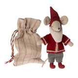 Toy mouse in a red outfit with a matching bag on a white background