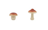 Two small mushroom figurines on a white background
