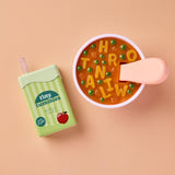 Tiny Tummies juice box next to a cup with a popsicle on a beige background
