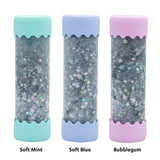Three cylindrical containers with colorful lids labeled 'Soft Mint', 'Soft Blue', and 'Bubblegum' on a white background.