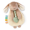Plush bunny toy with teething ring and colorful tabs on a white background