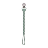 Mint green pacifier clip on a white background