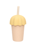 Yellow and beige cup with a straw on a white background