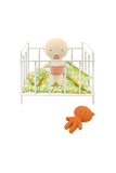 Baby crib with a baby doll and a soft toy on a white background