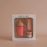 Baby bottle and sippy cup set in Tiny Harlow packaging on a beige background