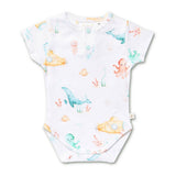 A white short-sleeve baby bodysuit with a watercolor-style underwater print featuring blue whales, yellow submarines, an orange octopus, and small fish, shown on a plain white background.