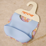 Silicone bib with colorful pattern on a beige background