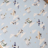 Pattern of vintage airplanes and helicopters on a light blue background