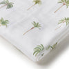 White fabric with green palm tree patterns on a white background