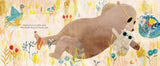 A whimsical illustrated scene showing a large brown bear lying among tall golden grass, with a small white rabbit beside it. The background is a soft pastel meadow with flowers and birds, and there is small printed text on the left side.