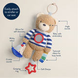 Teddy bear toy with features labeled on a beige background