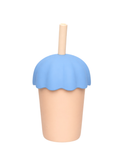 Blue ice cream-shaped lid on a beige cup with a wooden straw against a white background