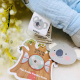 Koko the koala-themed product with a tag and a plush toy in the background.