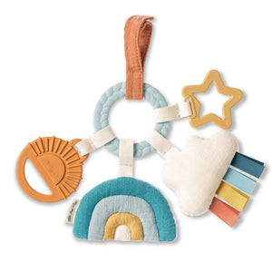 Colorful baby teething ring with various shapes on a white background
