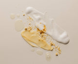 Mixture of white foam, yellow cream, and brown crumbs on a beige background