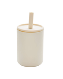 White ceramic container with a straw on a white background
