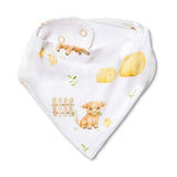 A white triangular bandana bib with a watercolor-style print of a cow, chicks, a fence, and small green leaves, shown on a plain white background.