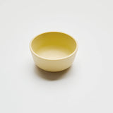 Yellow ceramic bowl on a light gray background