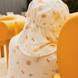 Baby outfit with sun and cloud pattern in a yellow chair