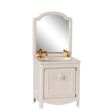 White bathroom vanity with mirror and gold fixtures on a white background