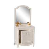 White bathroom vanity with mirror and gold fixtures on a white background