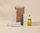 Collection of Bare skincare products including a box, bottle, and tube on a beige background