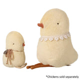Two plush chickens with lace details on a white background