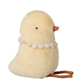 Plush toy chick with lace collar on a white background