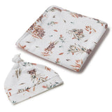 Baby blanket and hat set with animal print on a white background