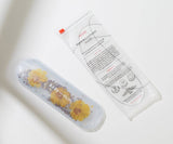 Product packaging with floral design and text on a light background