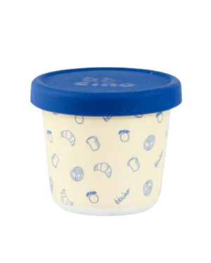 Small container with blue lid and patterned design on a white background