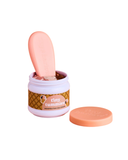 Jar of 'tiny tummies' ice cream with a pink spoon and a scoop removed on a white background