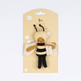 Bee-shaped plush toy in packaging on a light gray background