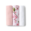 Three folded fabrics with different patterns on a white background