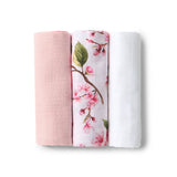 Three folded fabrics with different patterns on a white background