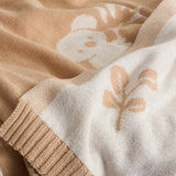 Close-up of a beige and white fabric with floral patterns