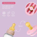 Baby Sprinkle gift set with pacifier and bottle on a light purple background