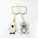 Two knitted stroller toys, one penguin and one koala, with a Living Textiles tag on a white background.