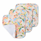 Set of four colorful baby diapers with a tropical fruit pattern on a white background