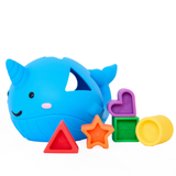 Blue whale-shaped toy with colorful geometric blocks on a white background
