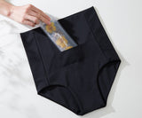 Black high-waisted underwear with a clear plastic bag containing flowers on a white background