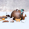 Set of small animal figurines on a textured surface with a blurred light background