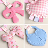 Collage of pink and blue baby teething toys with floral and checkered designs.