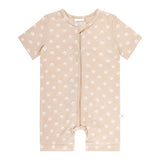 Beige baby romper with white polka dots on a white background