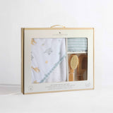 Baby bath gift set with towel, brush, and comb in a Living Textiles packaging on a white background