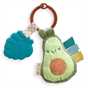 Avocado-shaped plush toy with teether and rattle on a white background